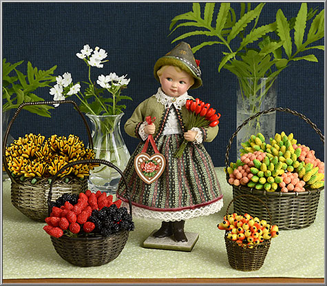 doll with baskets of vintage mini millinery fruits