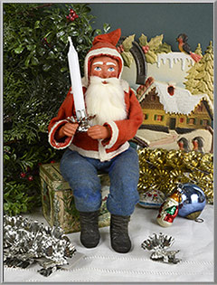 Santa Claus and his favorite clip-on Christmas tree candle holders from Germany
